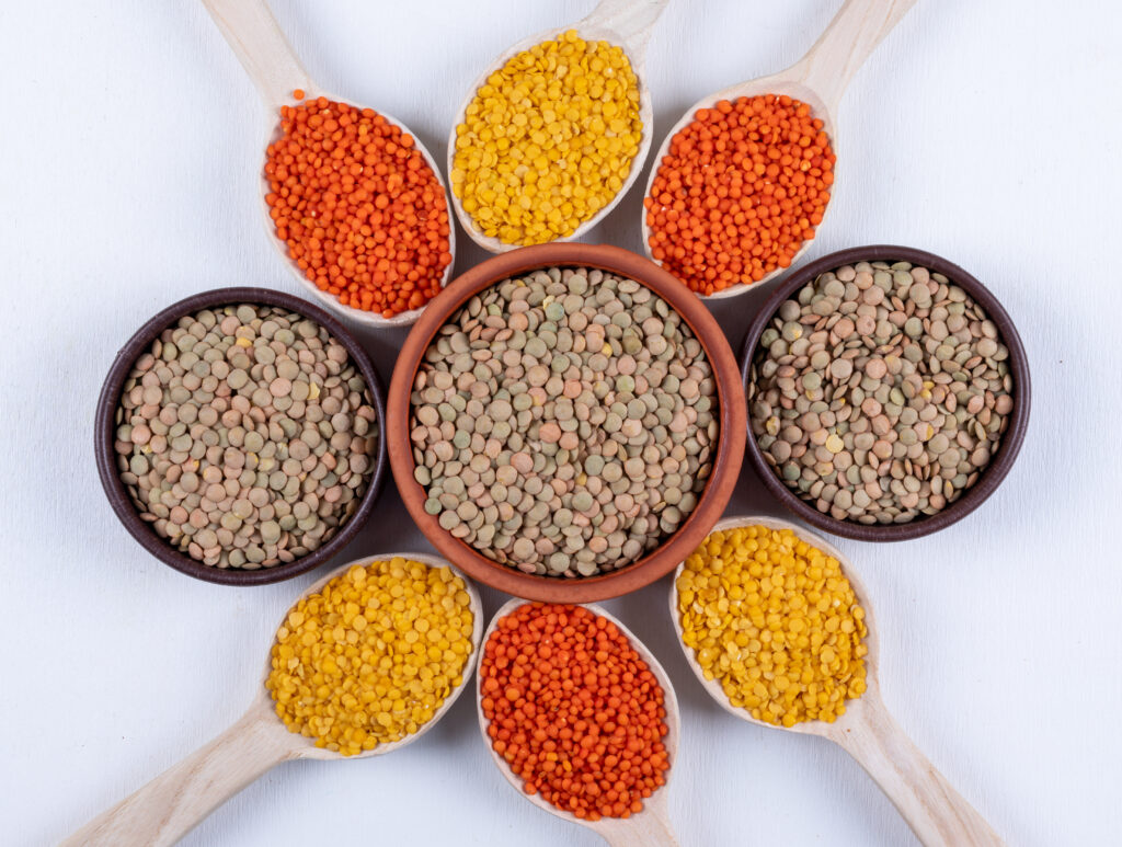 top view different lentils brown bowls wooden spoons